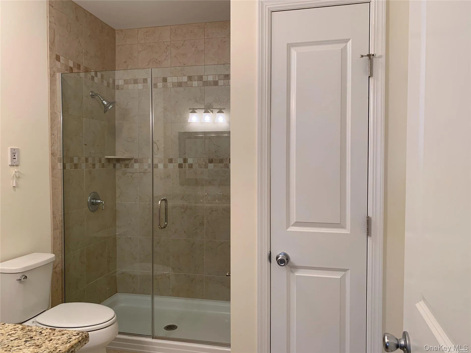Bathroom with a shower stall Bathroom with a shower stall