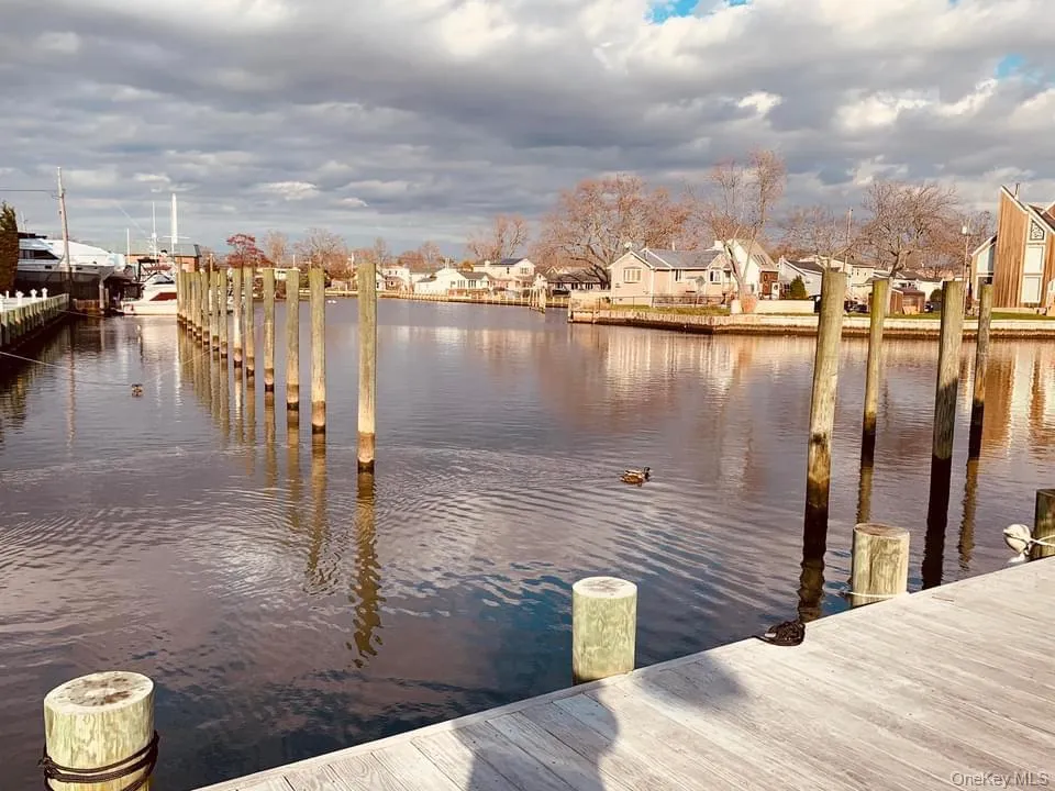 Dock with a water view and a residential view Dock with a water view and a residential view