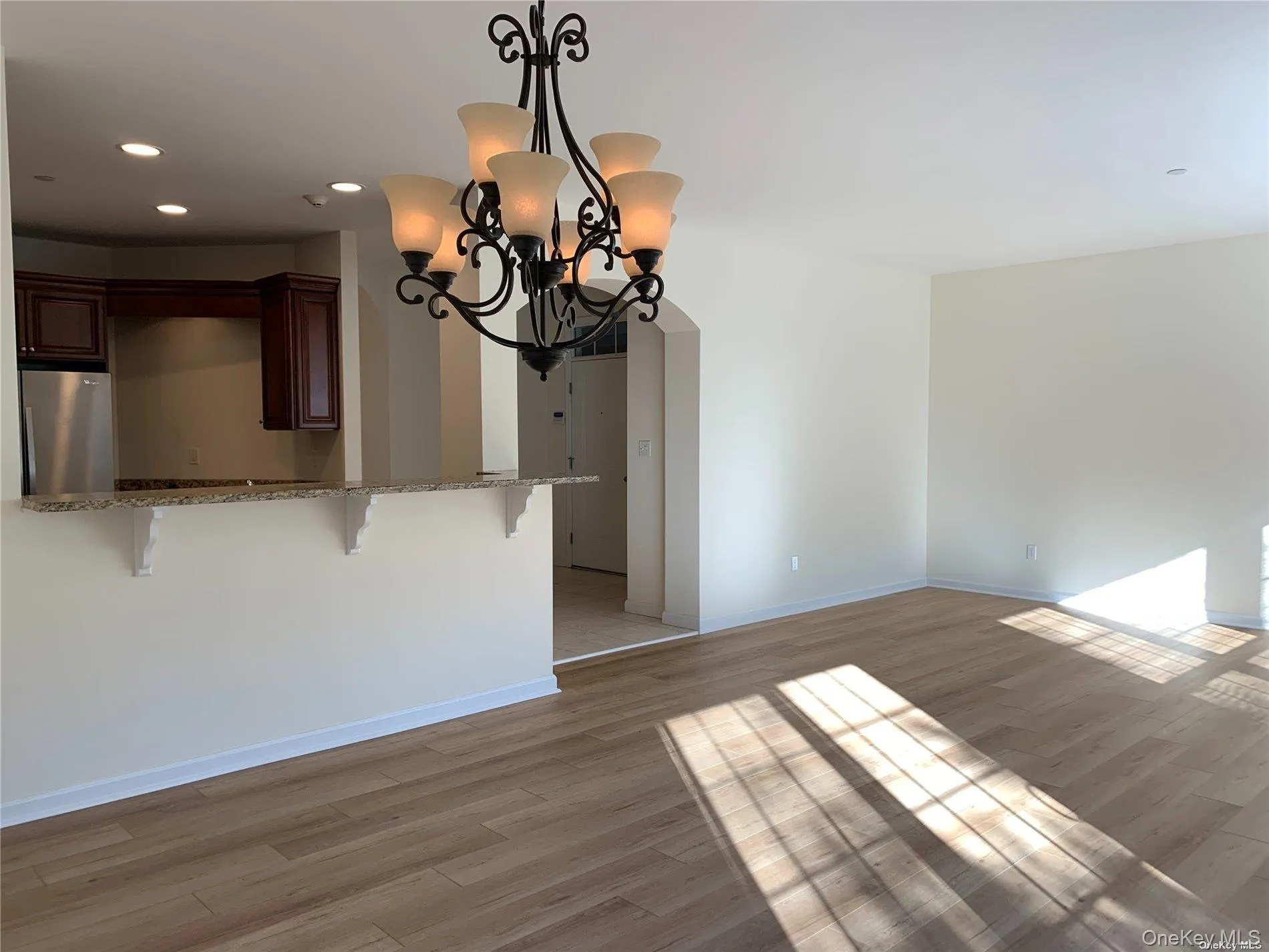 Unfurnished dining area featuring a chandelier, light wood finished floors, and recessed lighting Unfurnished dining area featuring a chandelier, light wood finished floors, and recessed lighting