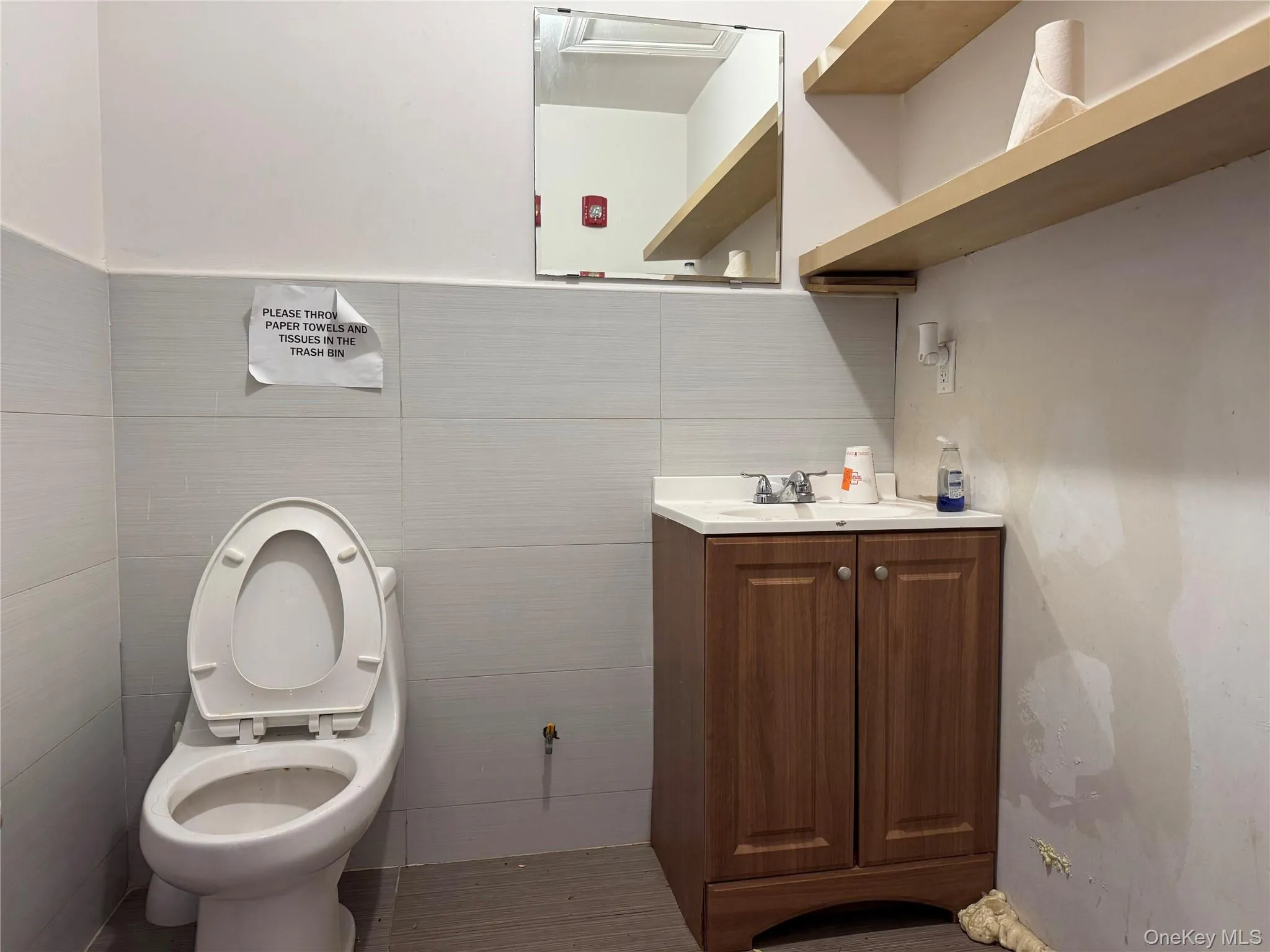 Bathroom featuring vanity and tile walls Bathroom featuring vanity and tile walls
