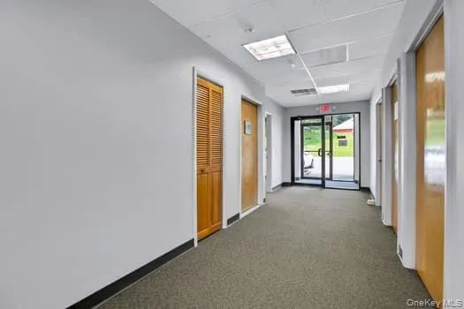 Corridor with carpet floors and baseboards Corridor with carpet floors and baseboards