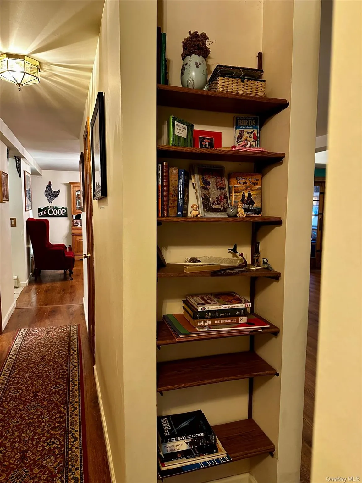 Hall featuring wood finished floors and baseboards Hall featuring wood finished floors and baseboards