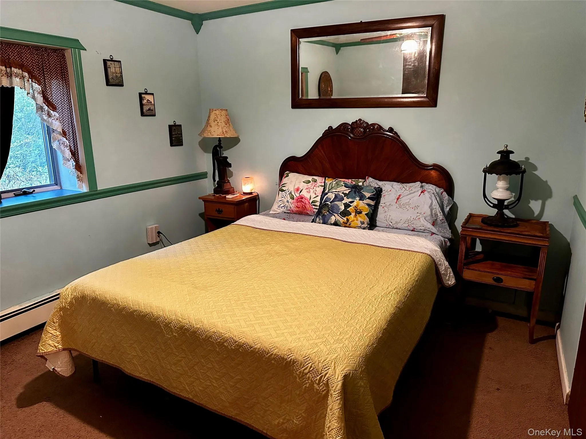 Bedroom with carpet and a baseboard radiator Bedroom with carpet and a baseboard radiator