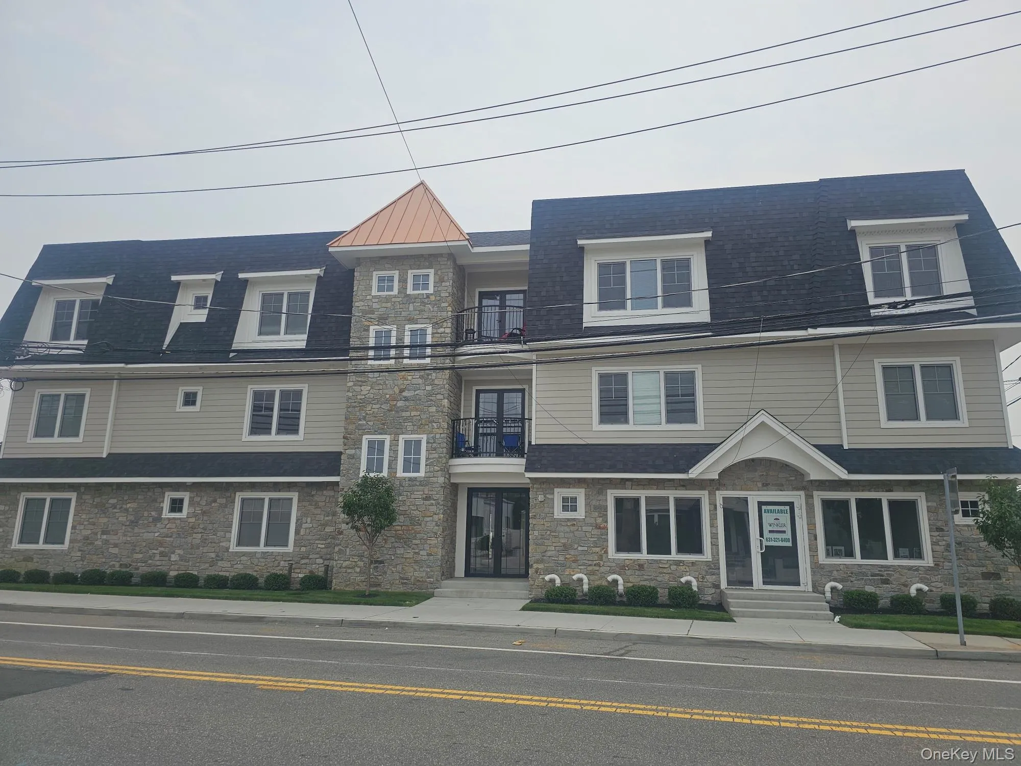 View of front of home featuring stone siding, a standing seam roof, and a metal roof View of front of home featuring stone siding, a standing seam roof, and a metal roof
