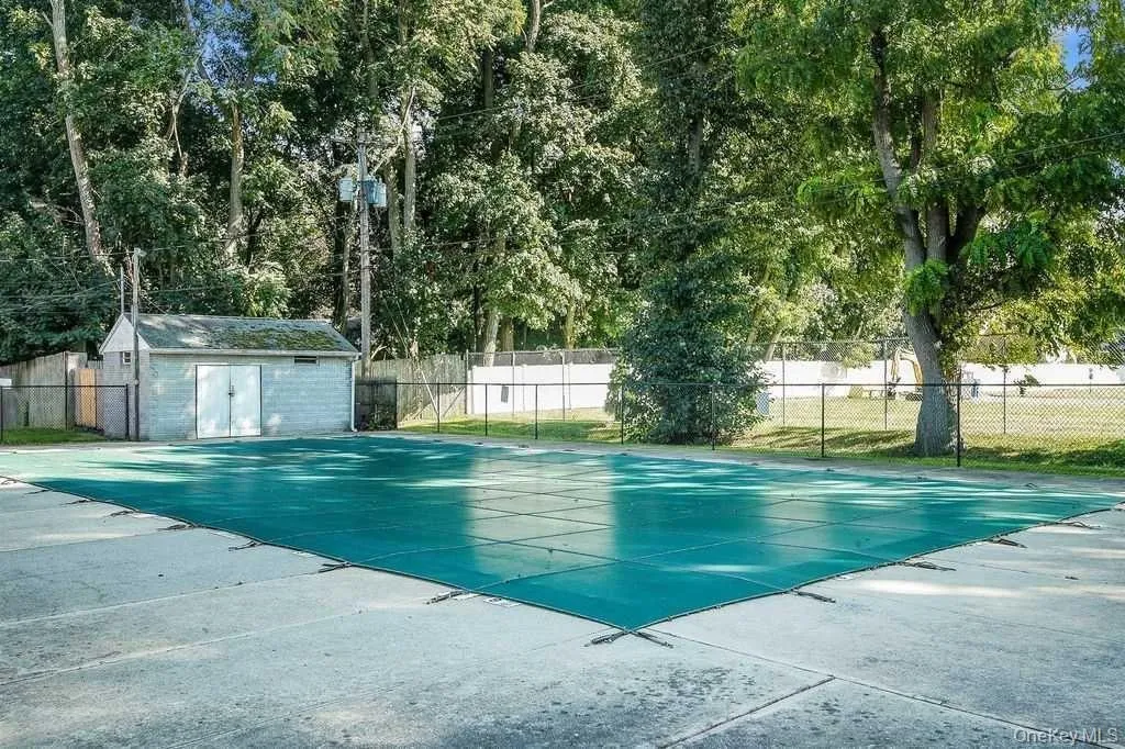 View of swimming pool featuring an outdoor structure View of swimming pool featuring an outdoor structure