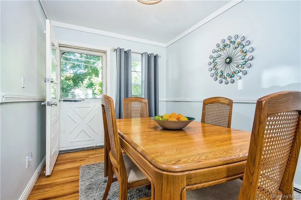 Dining area featuring light wood-type flooring and crown molding Dining area featuring light wood-type flooring and crown molding