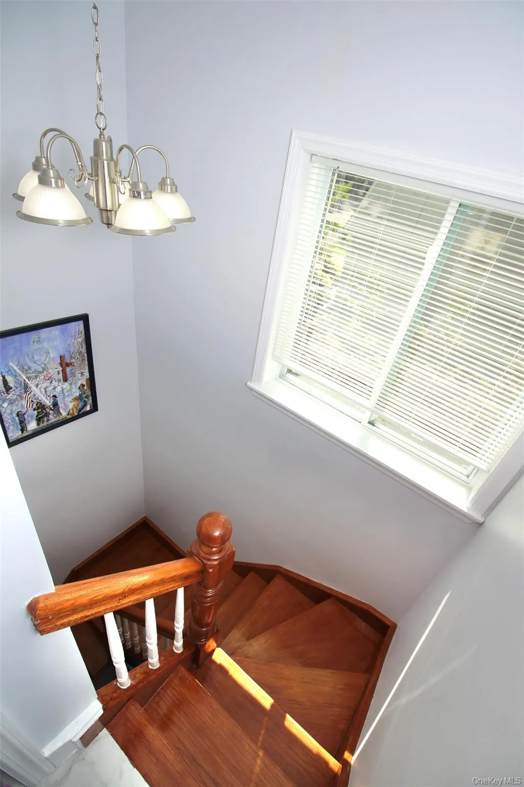 Stairway featuring wood finished floors and baseboards Stairway featuring wood finished floors and baseboards