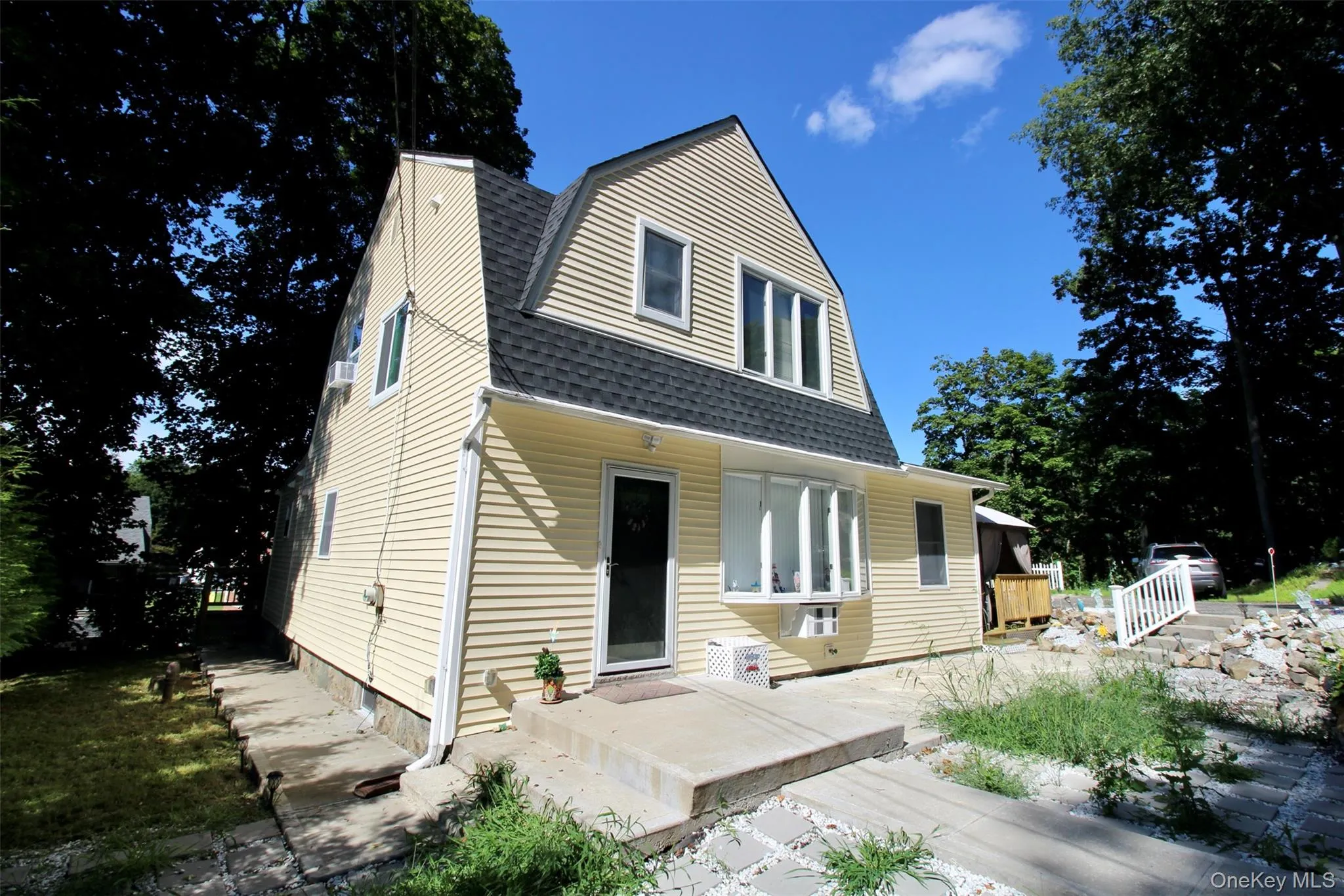 Dutch colonial featuring a gambrel roof and a shingled roof Dutch colonial featuring a gambrel roof and a shingled roof