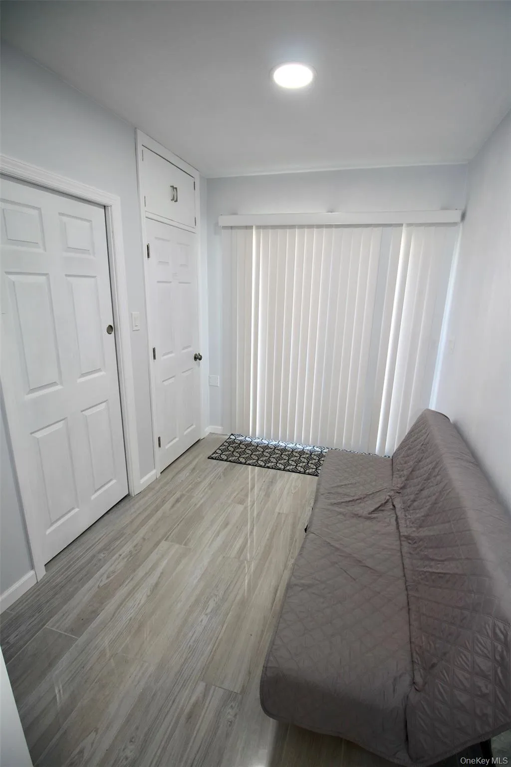 Bedroom with wood finished floors and a closet Bedroom with wood finished floors and a closet