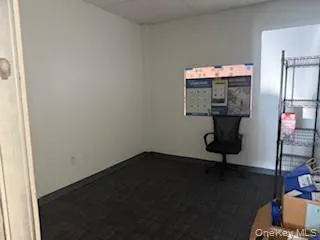 Unfurnished office featuring a drop ceiling and carpet Unfurnished office featuring a drop ceiling and carpet