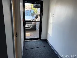 Doorway with carpet and baseboards Doorway with carpet and baseboards