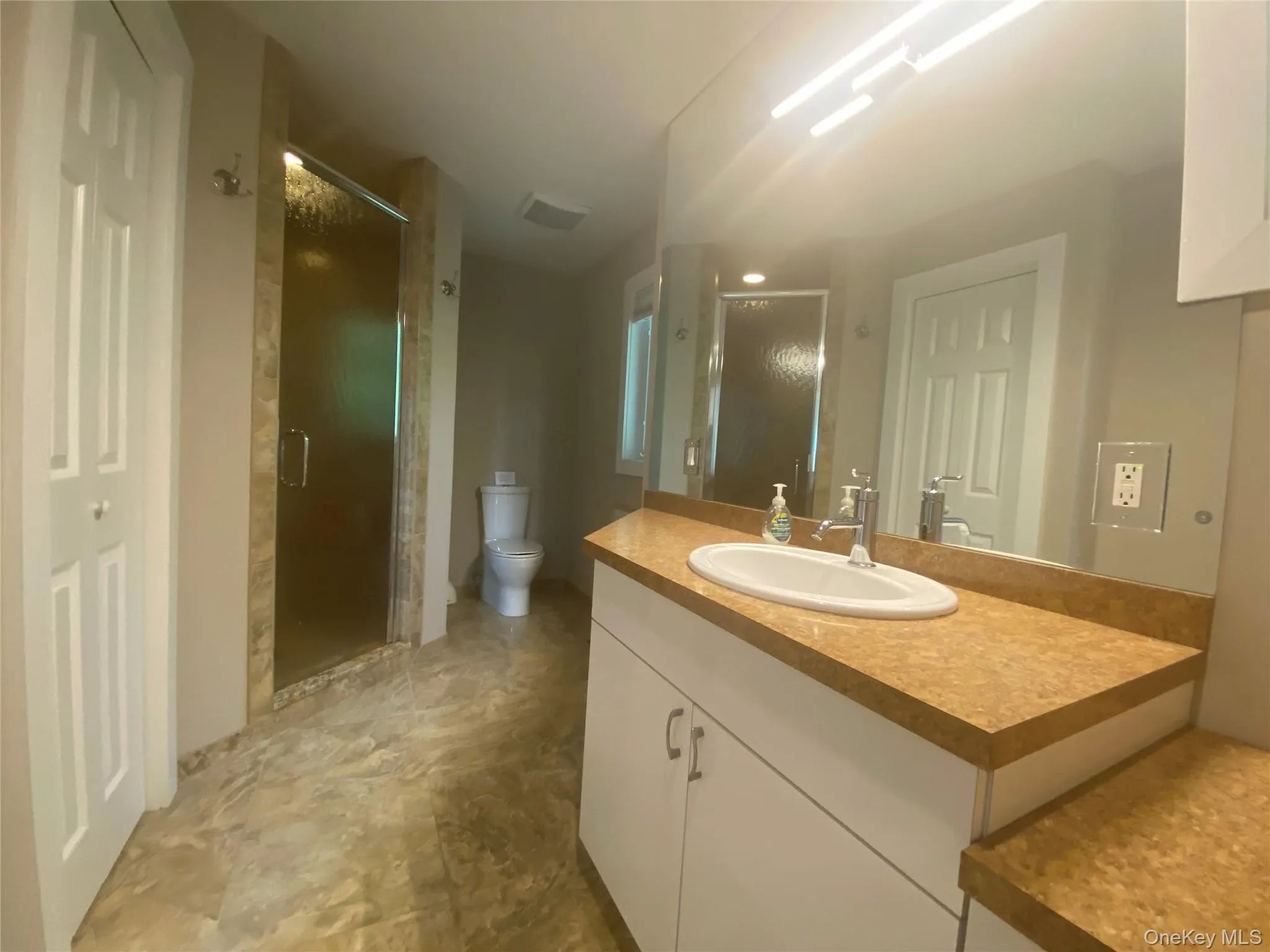 Full bath with vanity and a shower stall Full bath with vanity and a shower stall