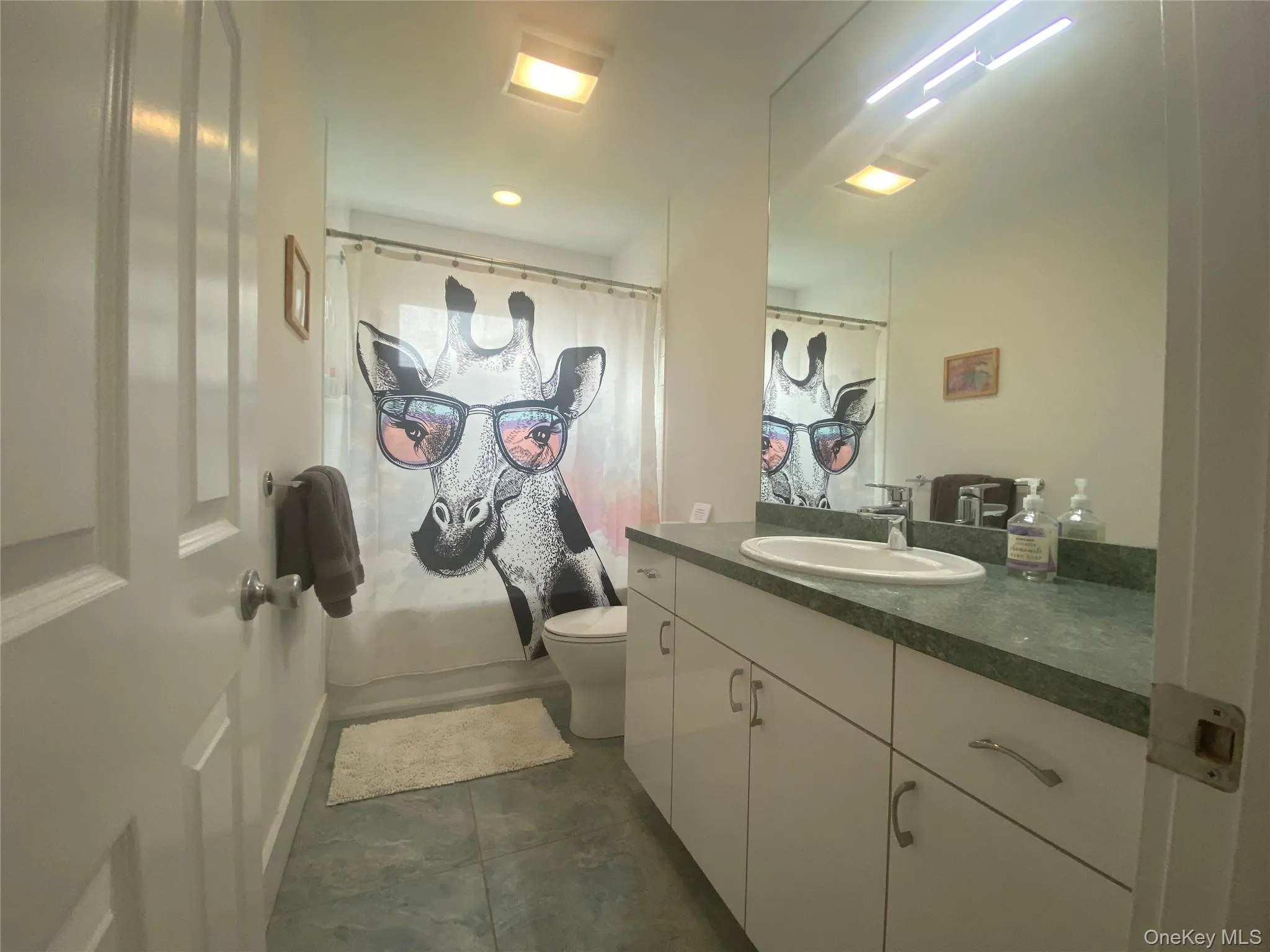 Bathroom featuring vanity and curtained shower Bathroom featuring vanity and curtained shower