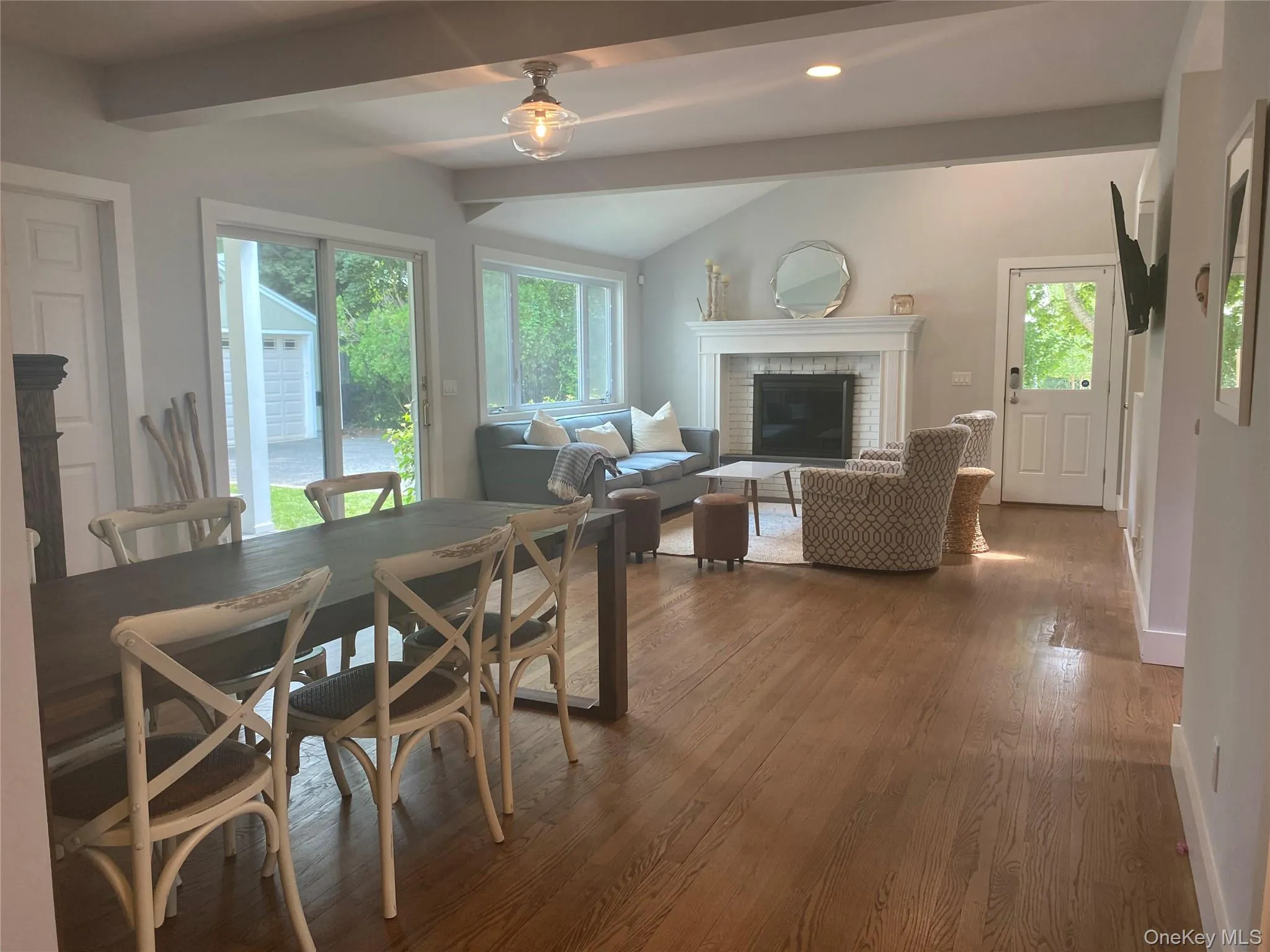 Dining space featuring a fireplace, dark wood-style flooring, and recessed lighting Dining space featuring a fireplace, dark wood-style flooring, and recessed lighting