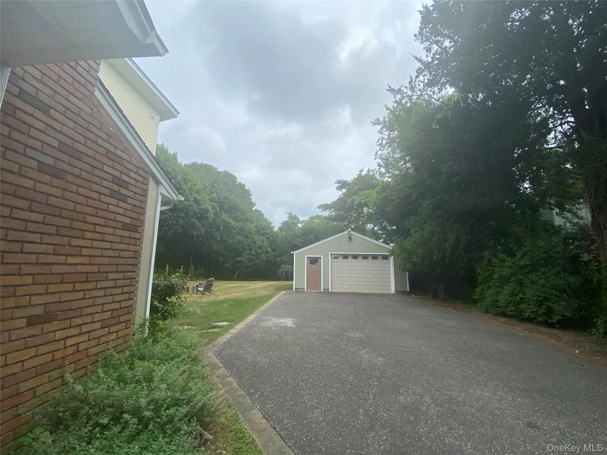 View of home's exterior with brick siding, an outbuilding, and a garage View of home's exterior with brick siding, an outbuilding, and a garage
