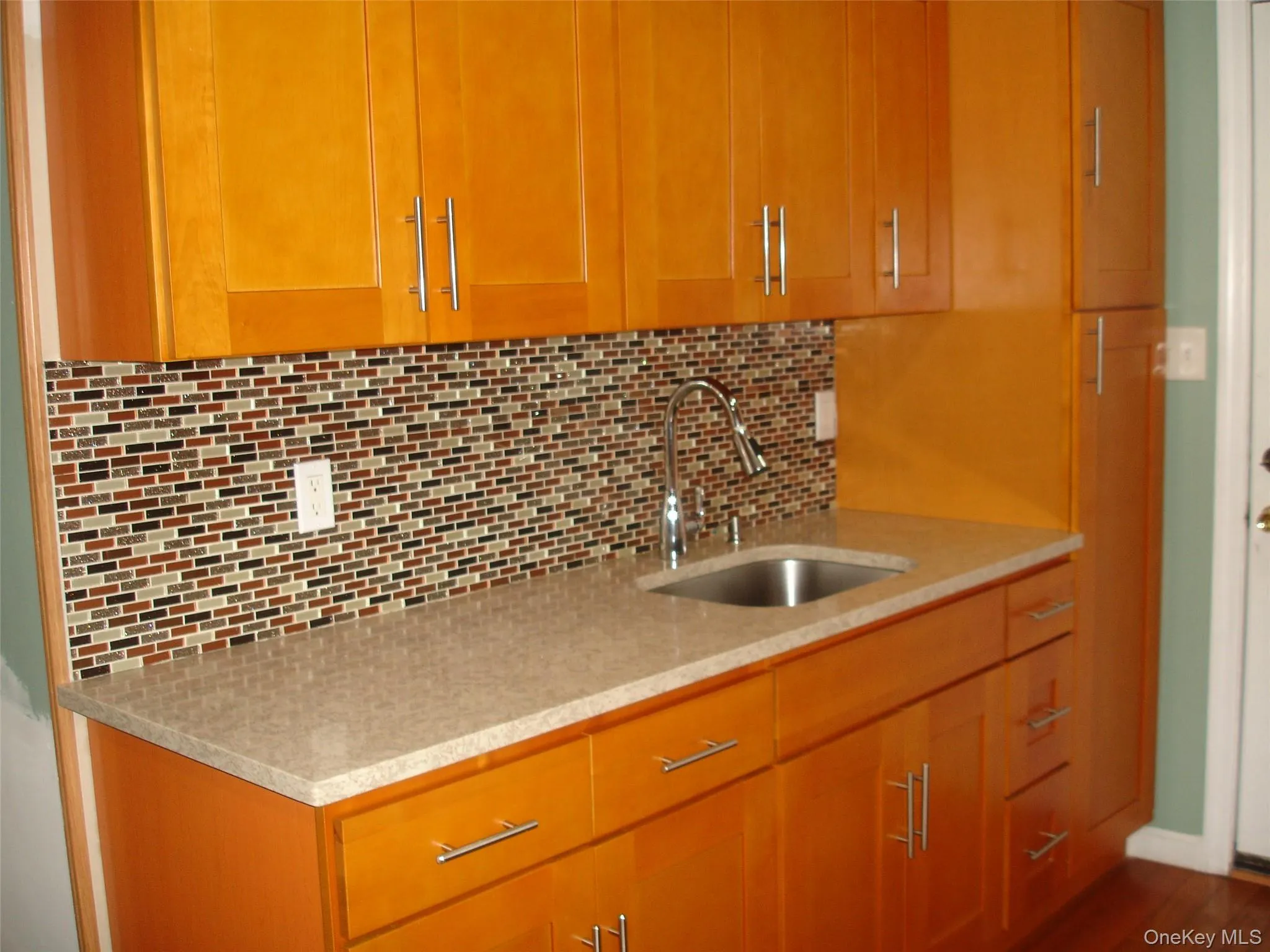 Kitchen with tasteful backsplash and light stone counters Kitchen with tasteful backsplash and light stone counters