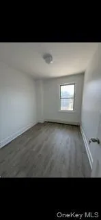 Unfurnished room featuring baseboards and wood finished floors Unfurnished room featuring baseboards and wood finished floors