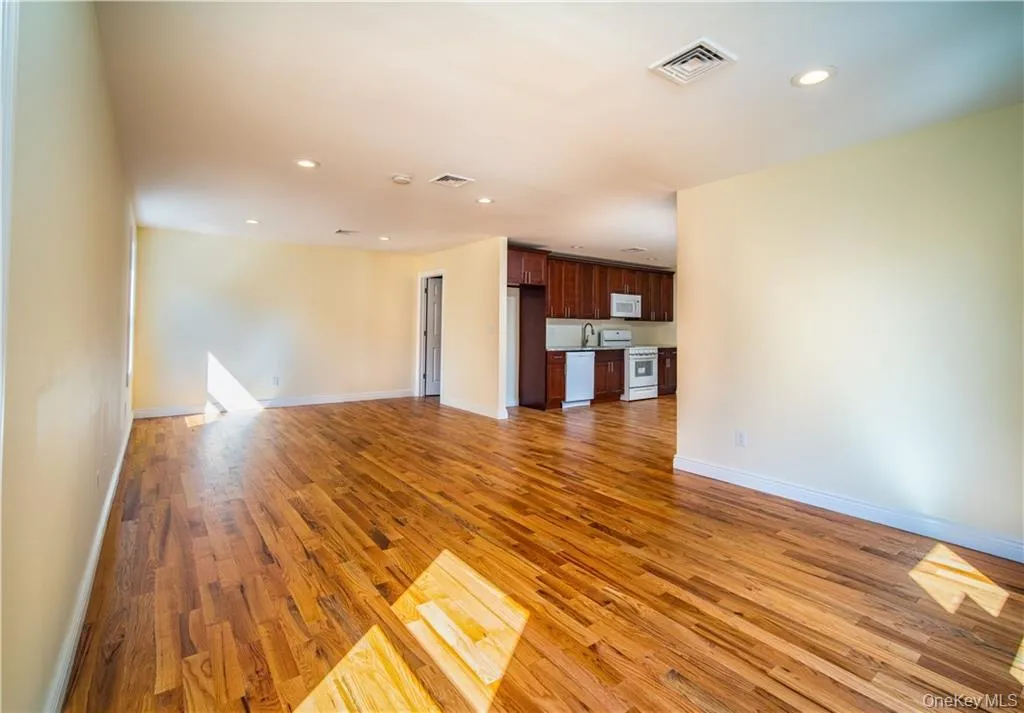 Unfurnished living room with light wood finished floors and recessed lighting Unfurnished living room with light wood finished floors and recessed lighting