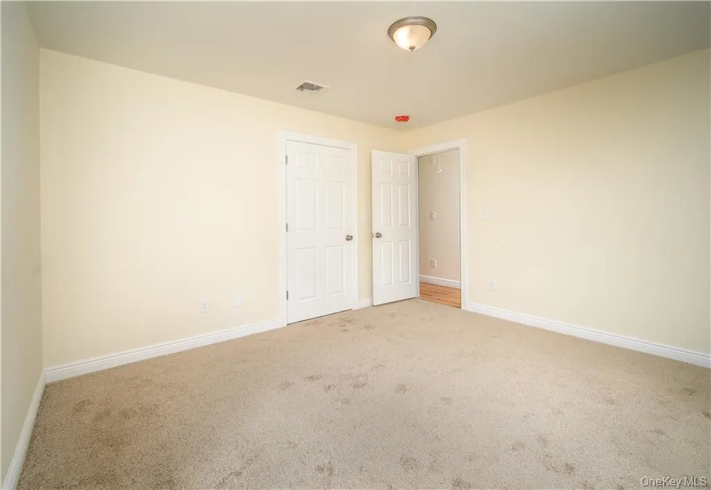Unfurnished bedroom with carpet floors Unfurnished bedroom with carpet floors