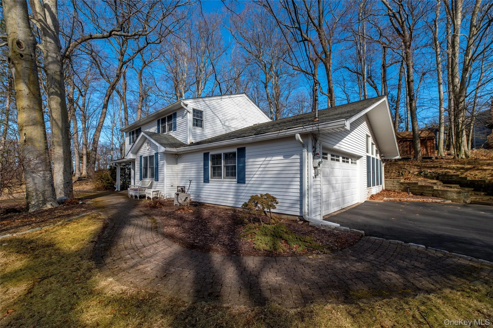 View of side of property featuring driveway and a garage View of side of property featuring driveway and a garage