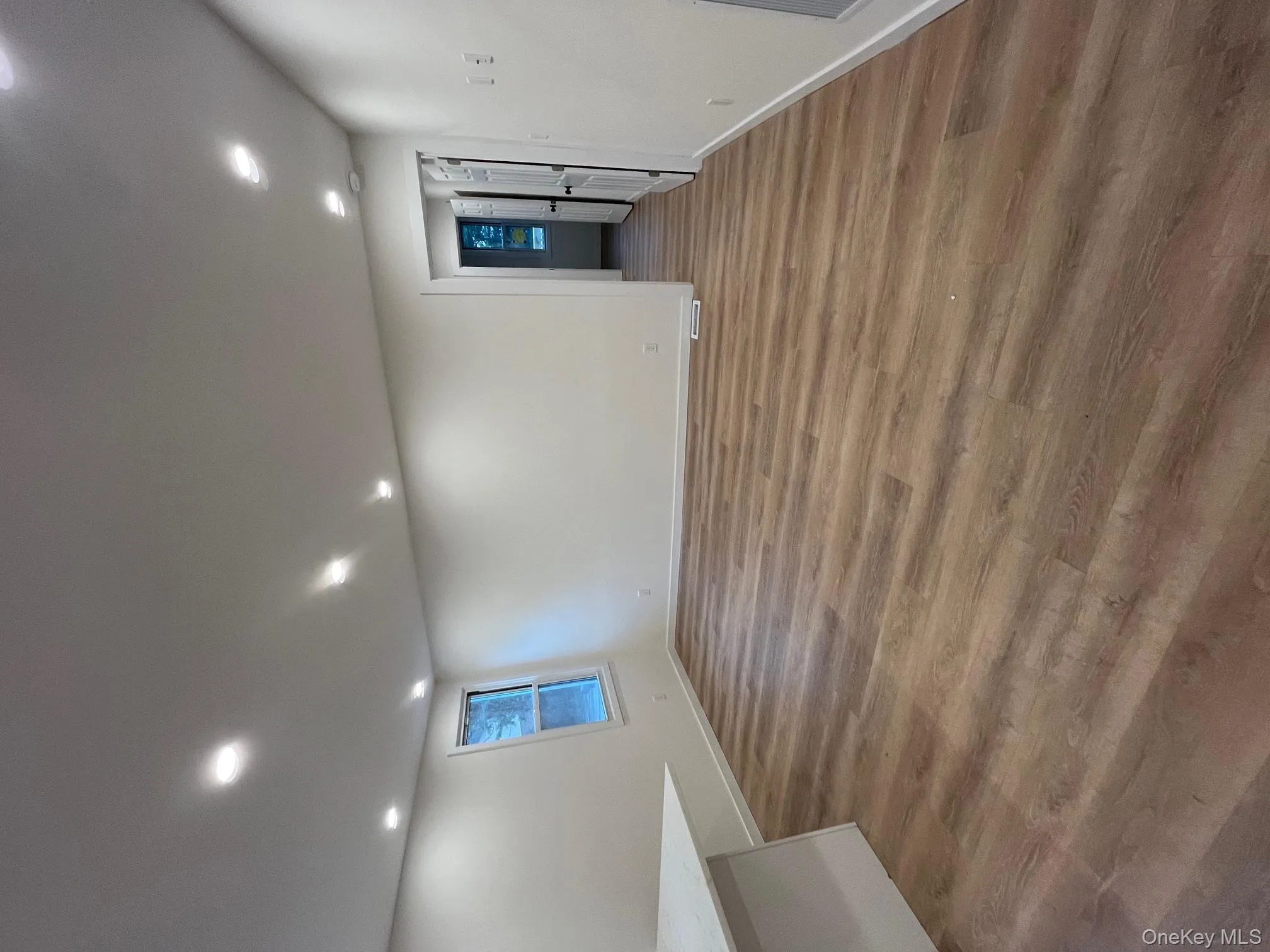 Basement with recessed lighting and light wood finished floors Basement with recessed lighting and light wood finished floors