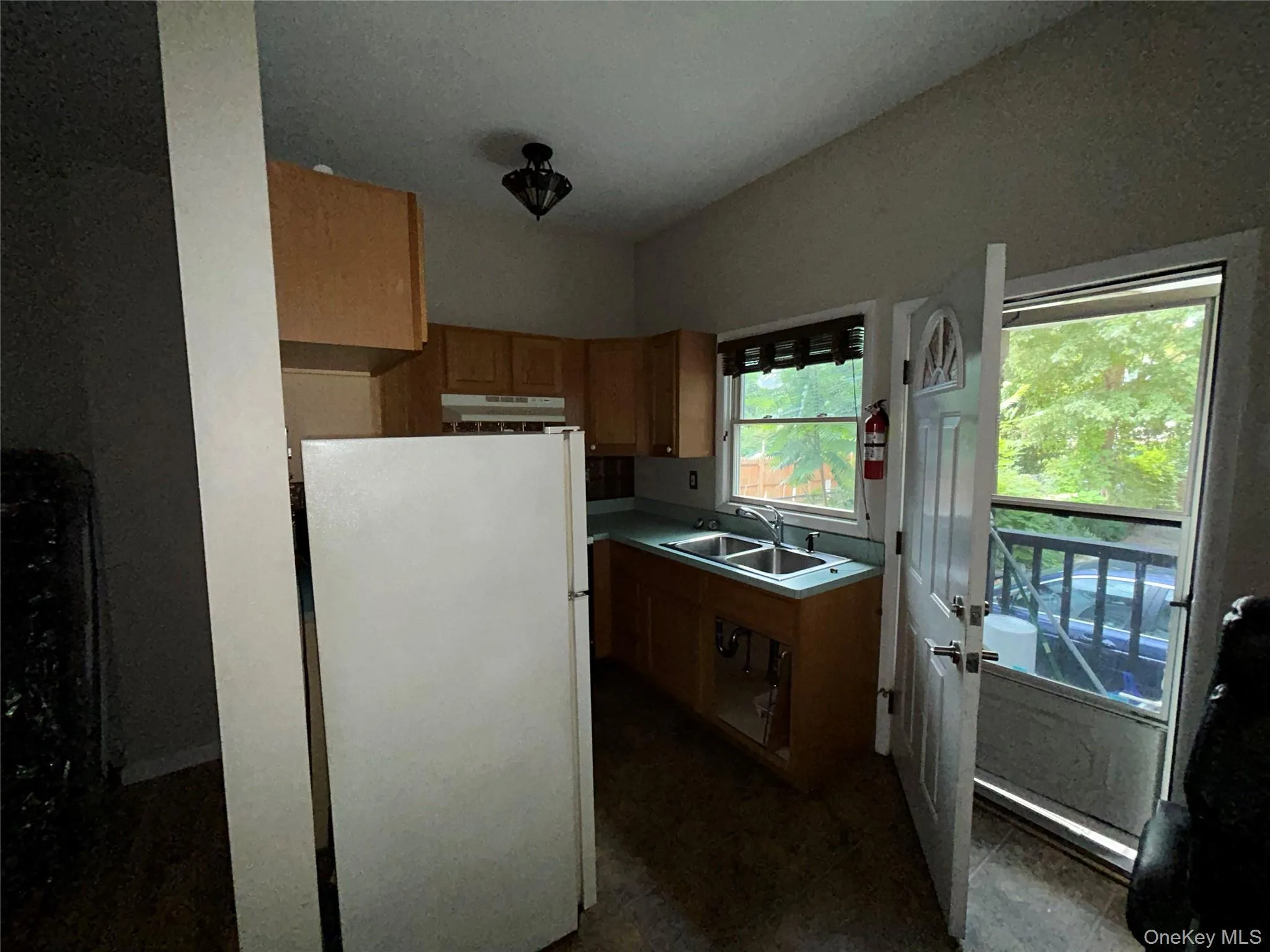 Kitchen with freestanding refrigerator and light countertops Kitchen with freestanding refrigerator and light countertops