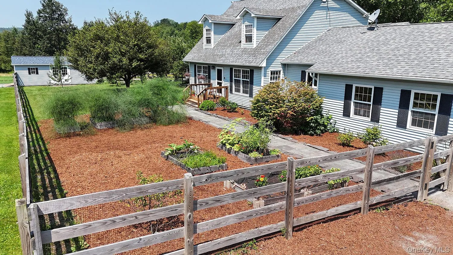 Cape cod home with a vegetable garden and roof with shingles Cape cod home with a vegetable garden and roof with shingles