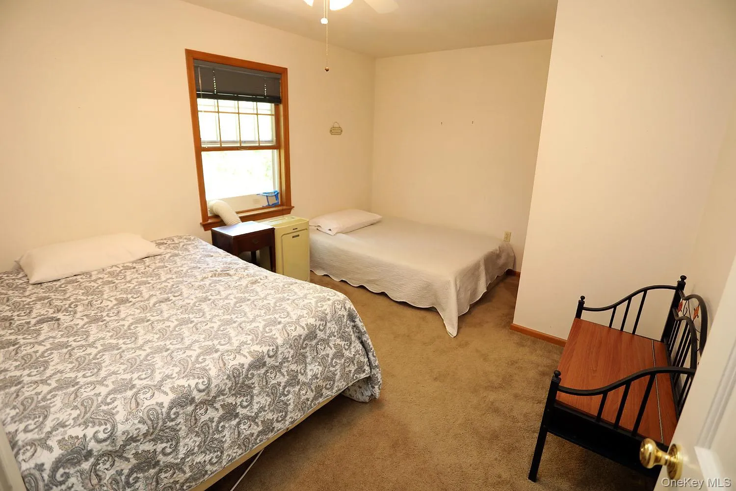 Carpeted bedroom with baseboards and a ceiling fan Carpeted bedroom with baseboards and a ceiling fan