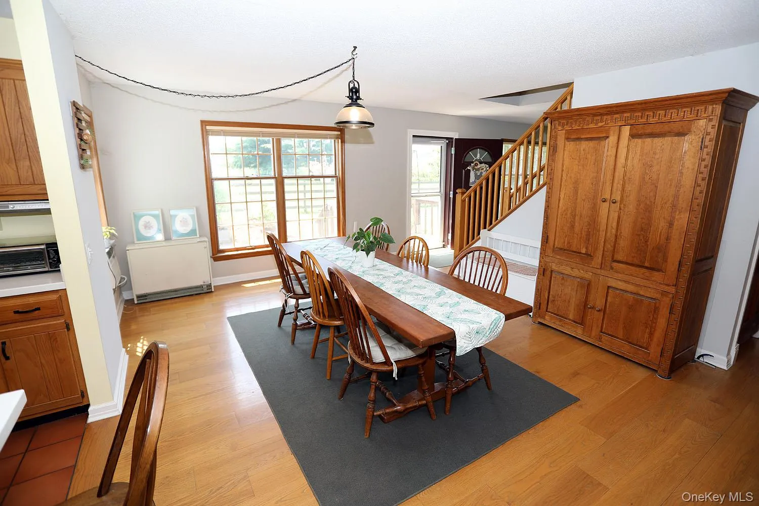 Dining area with stairway and light wood-style flooring Dining area with stairway and light wood-style flooring