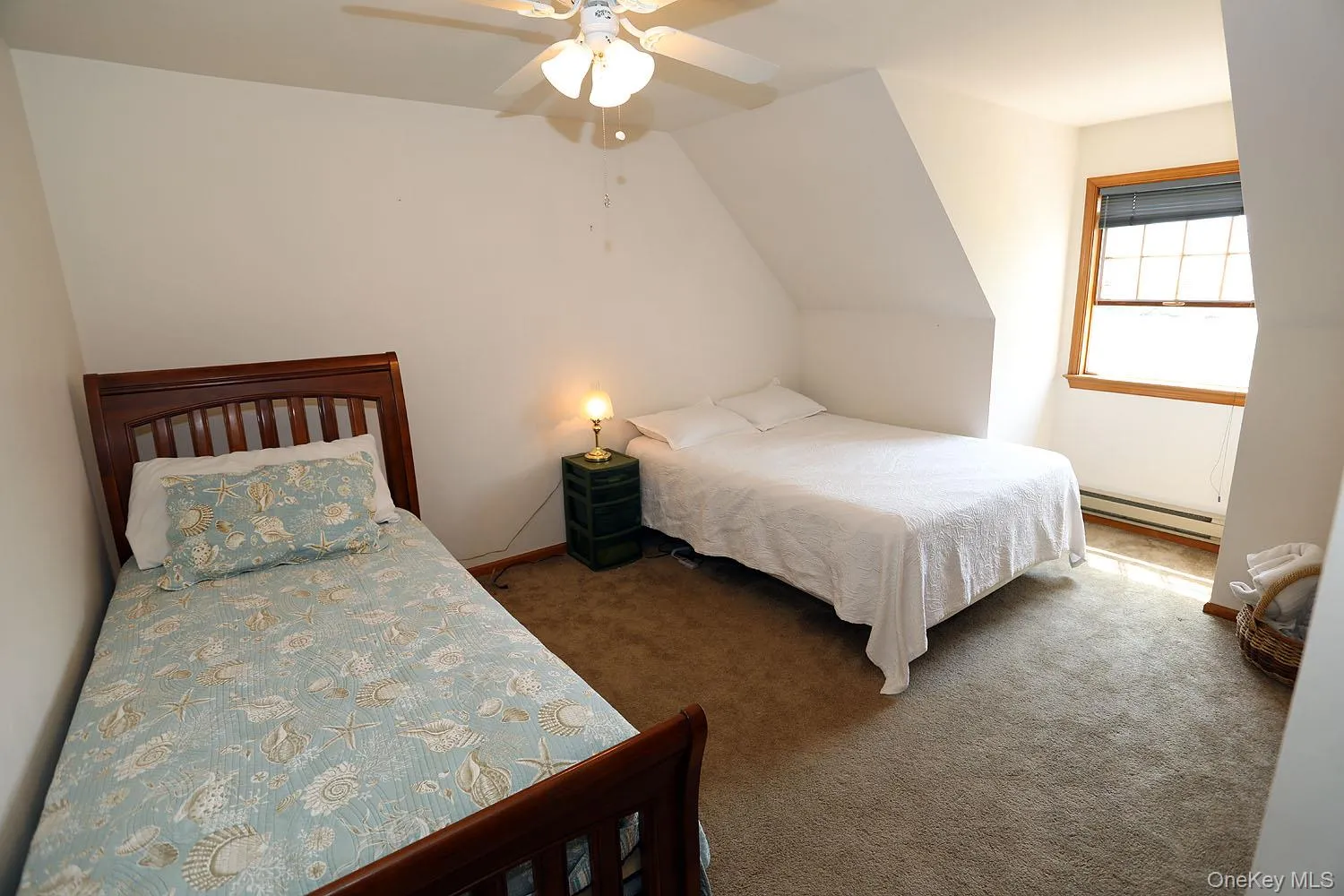 Bedroom with carpet, a baseboard heating unit, lofted ceiling, and ceiling fan Bedroom with carpet, a baseboard heating unit, lofted ceiling, and ceiling fan