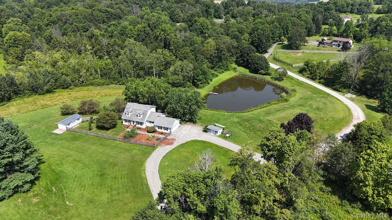 Bird's eye view of a heavily wooded area and a large body of water Bird's eye view of a heavily wooded area and a large body of water