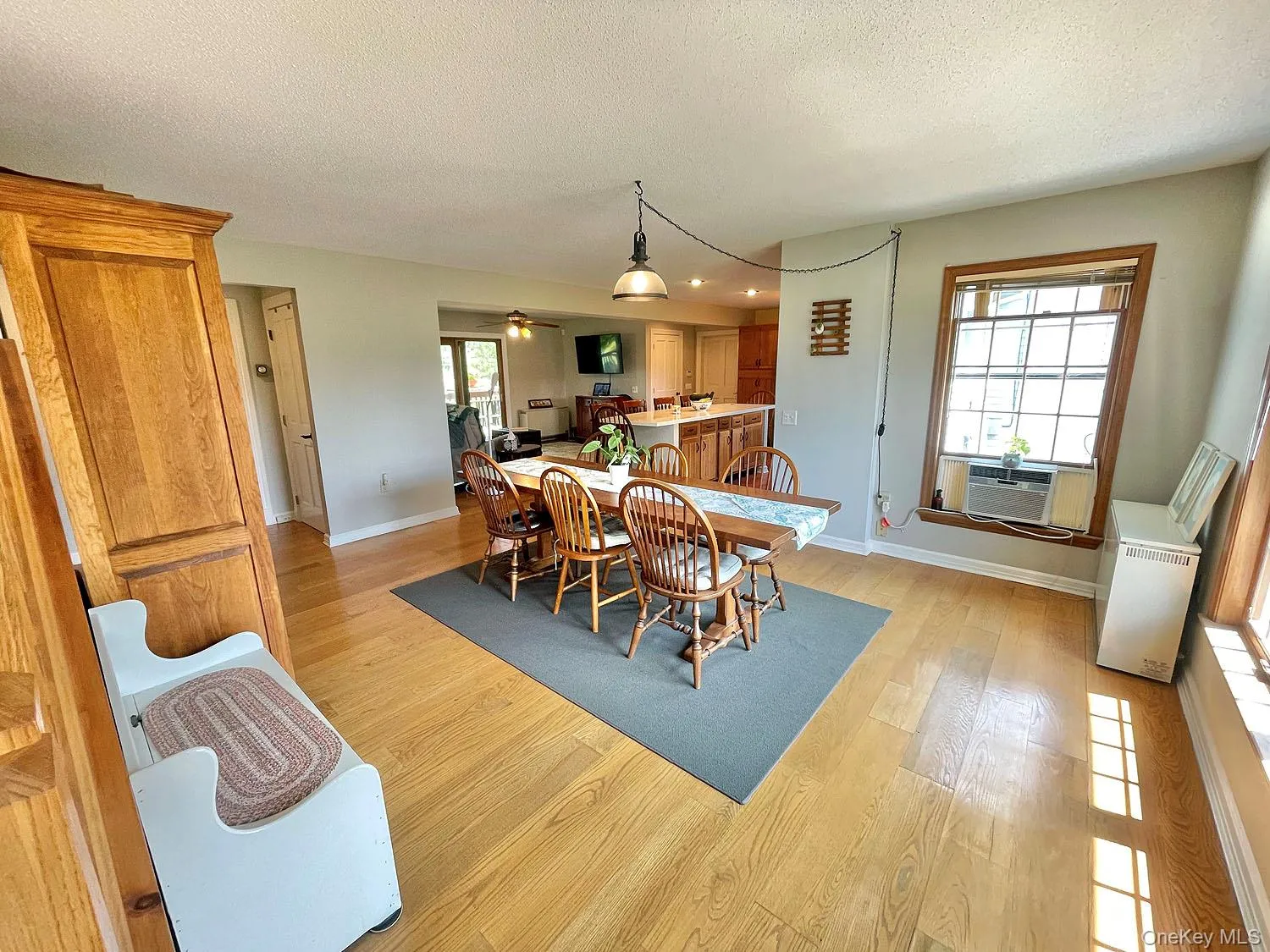 Dining area with a textured ceiling, light wood-type flooring, recessed lighting, and a ceiling fan Dining area with a textured ceiling, light wood-type flooring, recessed lighting, and a ceiling fan