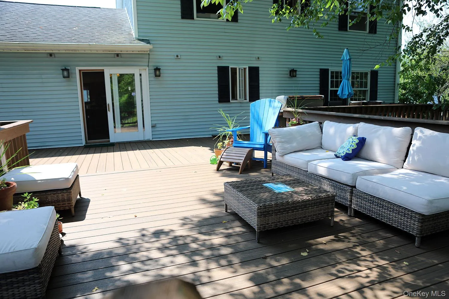 Wooden terrace featuring an outdoor living space Wooden terrace featuring an outdoor living space