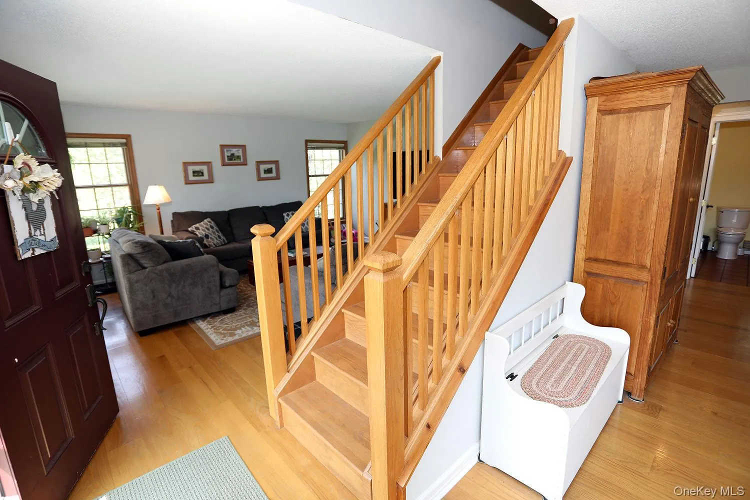 Staircase featuring plenty of natural light and wood finished floors Staircase featuring plenty of natural light and wood finished floors