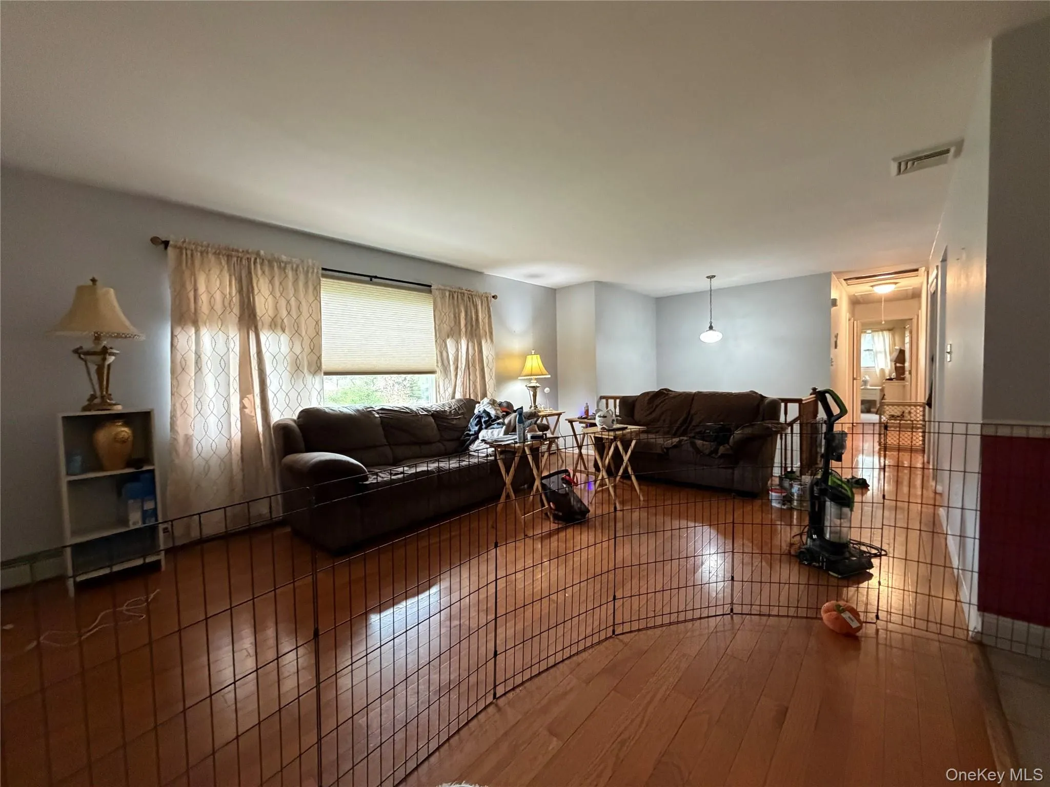 Spacious interior with hardwood flooring, platinum grey wall paint, and white trim Spacious interior with hardwood flooring, platinum grey wall paint, and white trim