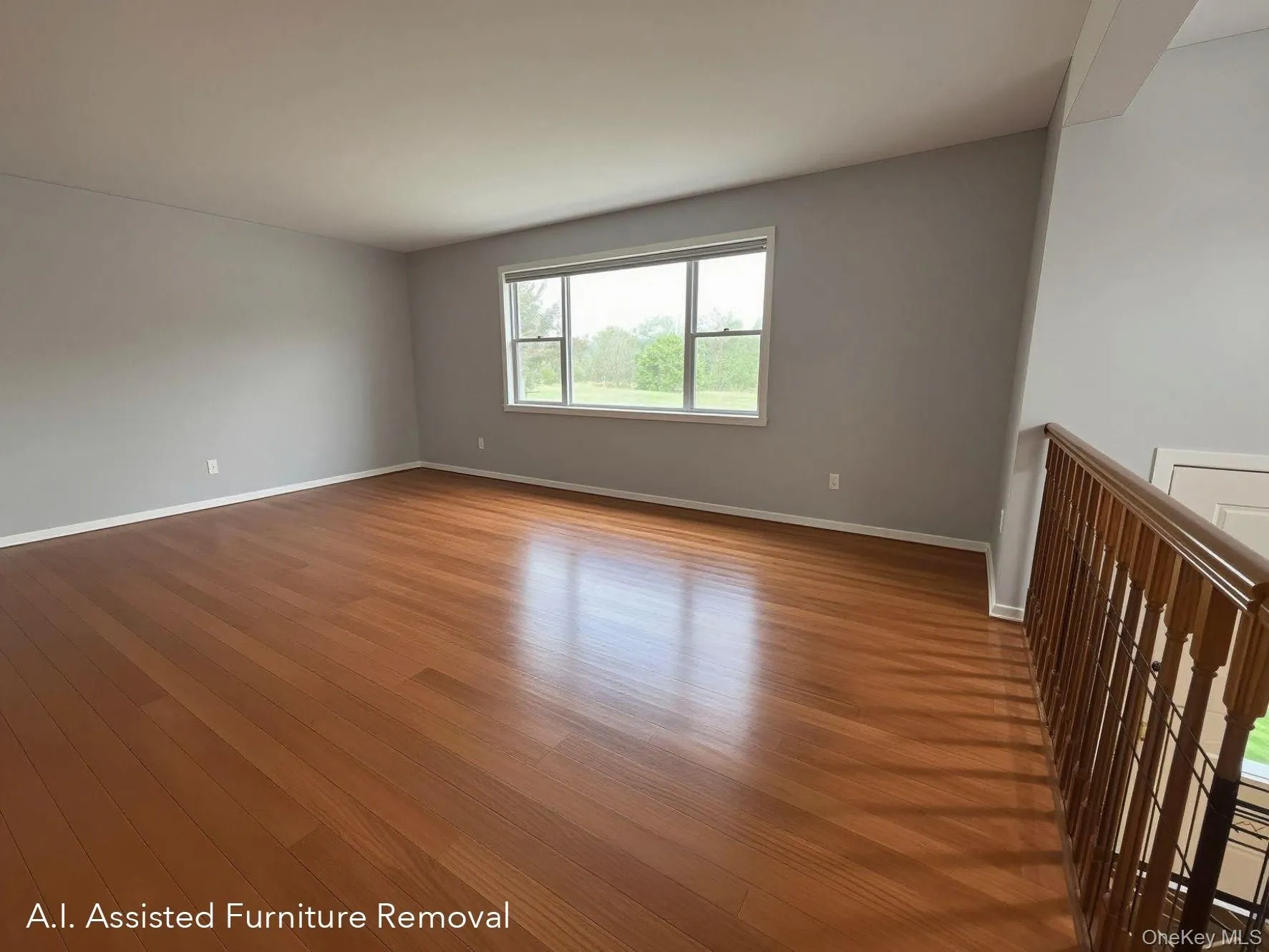 Primary living room is a well lit (south west exposure) and spacious, featuring wood floors, light gray wall paint, and white baseboards Primary living room is a well lit (south west exposure) and spacious, featuring wood floors, light gray wall paint, and white baseboards