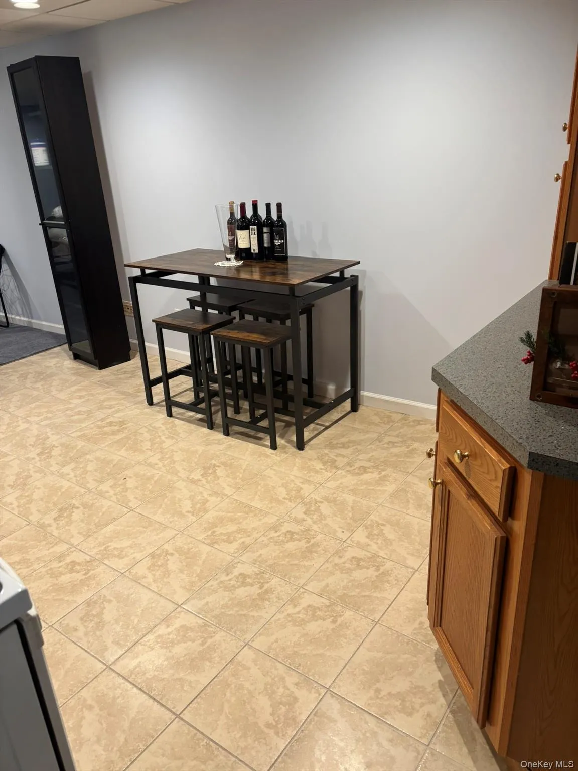 Dining area with baseboards and light tile patterned flooring Dining area with baseboards and light tile patterned flooring