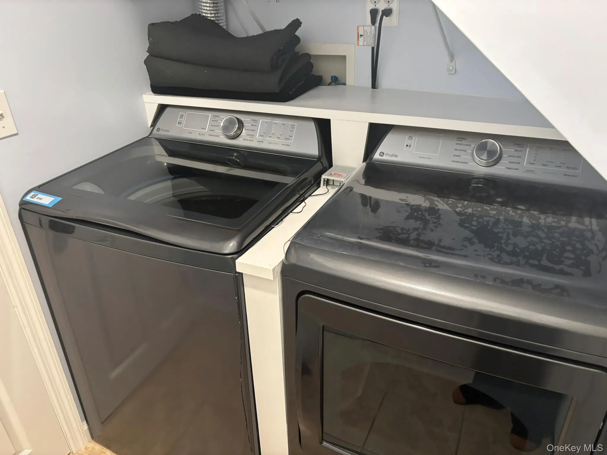 Washroom with washer and clothes dryer Washroom with washer and clothes dryer