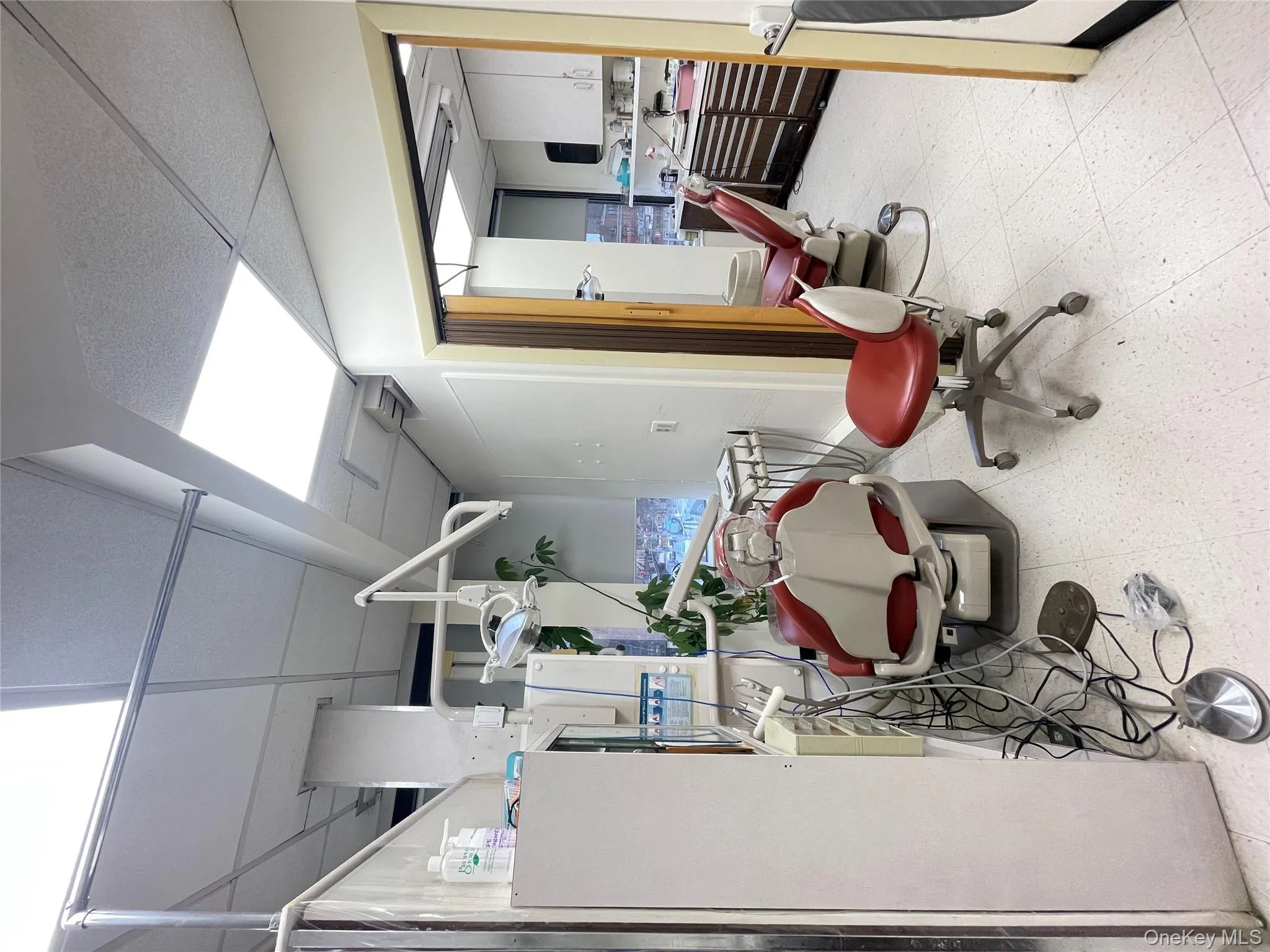 Home office with tile patterned floors and a paneled ceiling Home office with tile patterned floors and a paneled ceiling