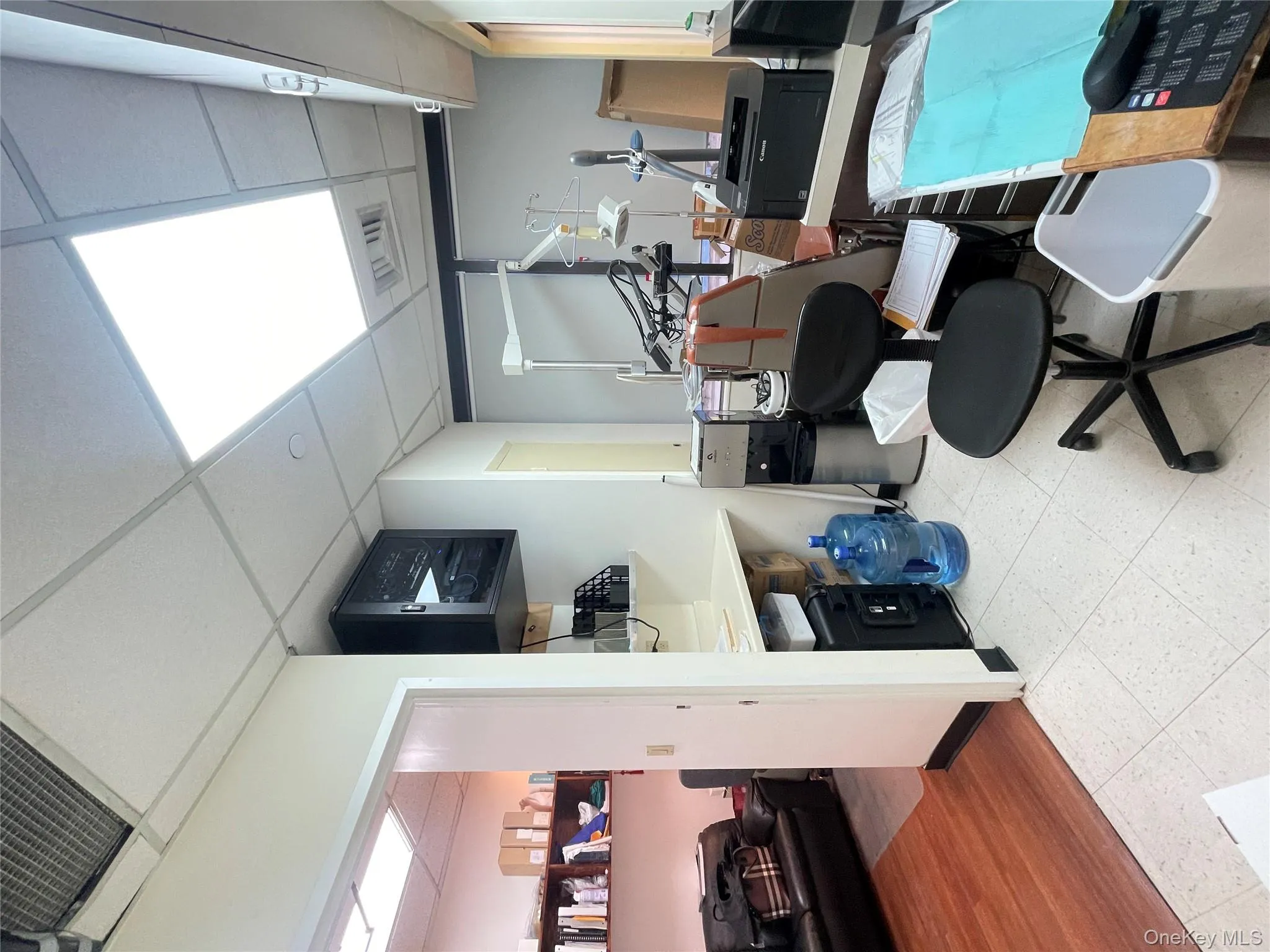 Office space featuring a drop ceiling and light flooring Office space featuring a drop ceiling and light flooring