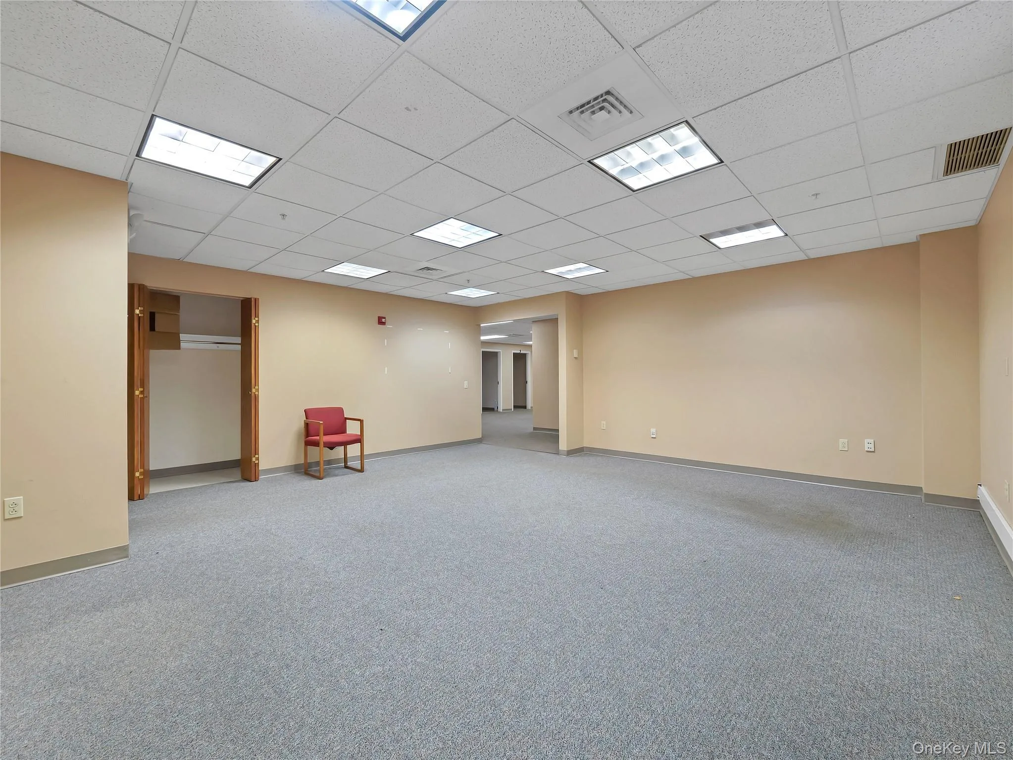 Spare room featuring carpet floors and a paneled ceiling Spare room featuring carpet floors and a paneled ceiling