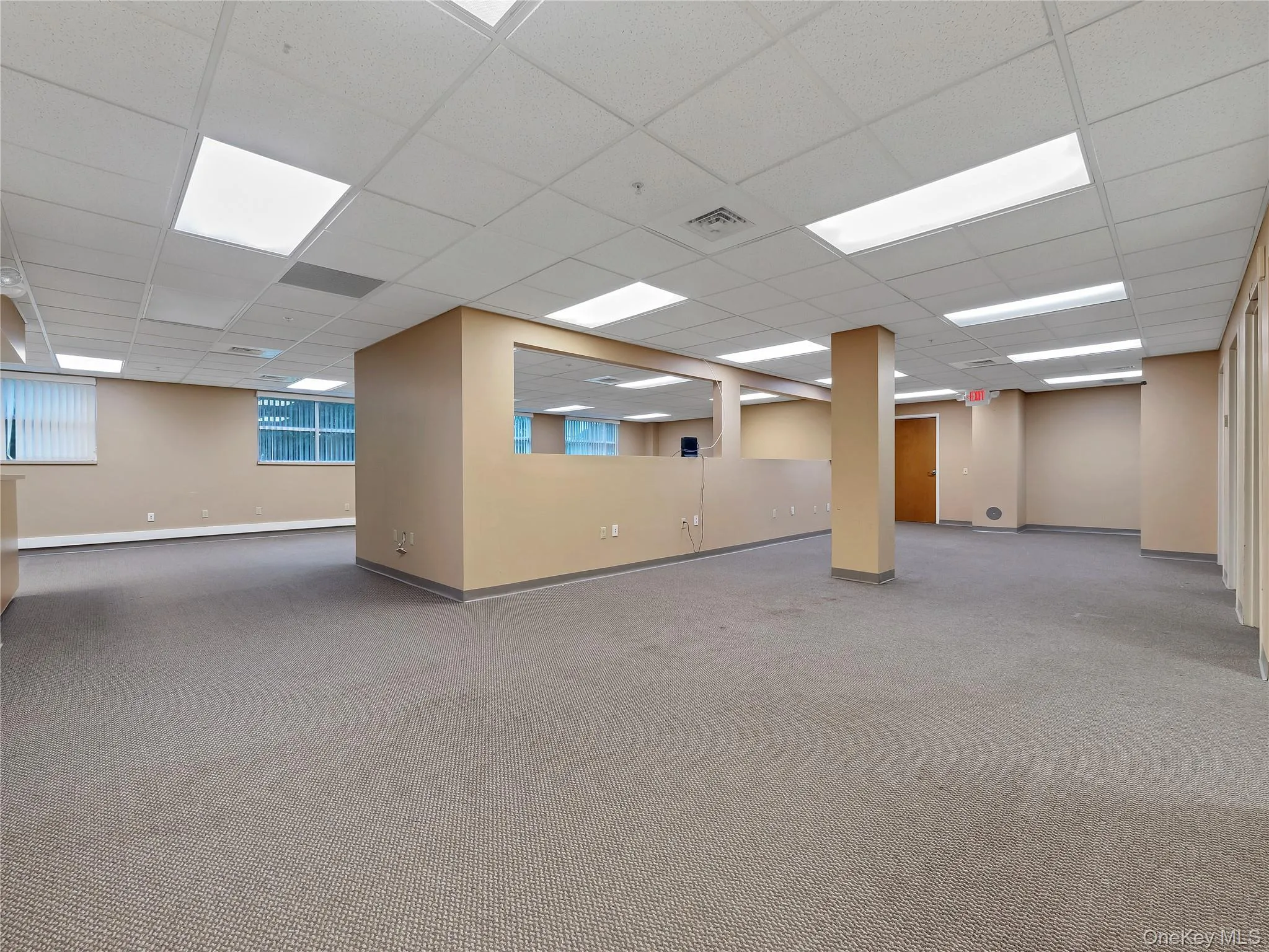 Spare room with carpet floors and a paneled ceiling Spare room with carpet floors and a paneled ceiling