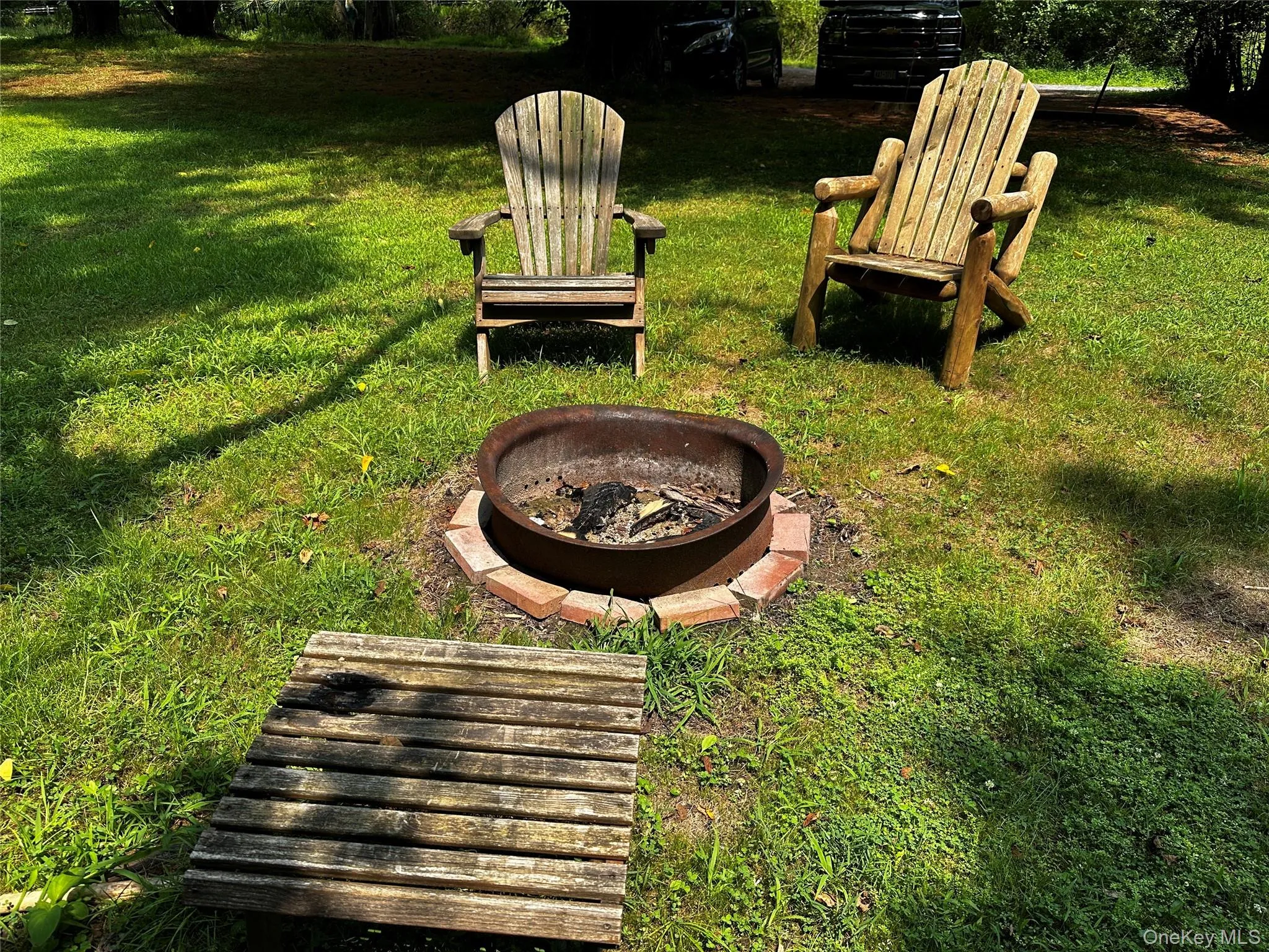 View of grassy yard featuring an outdoor fire pit View of grassy yard featuring an outdoor fire pit