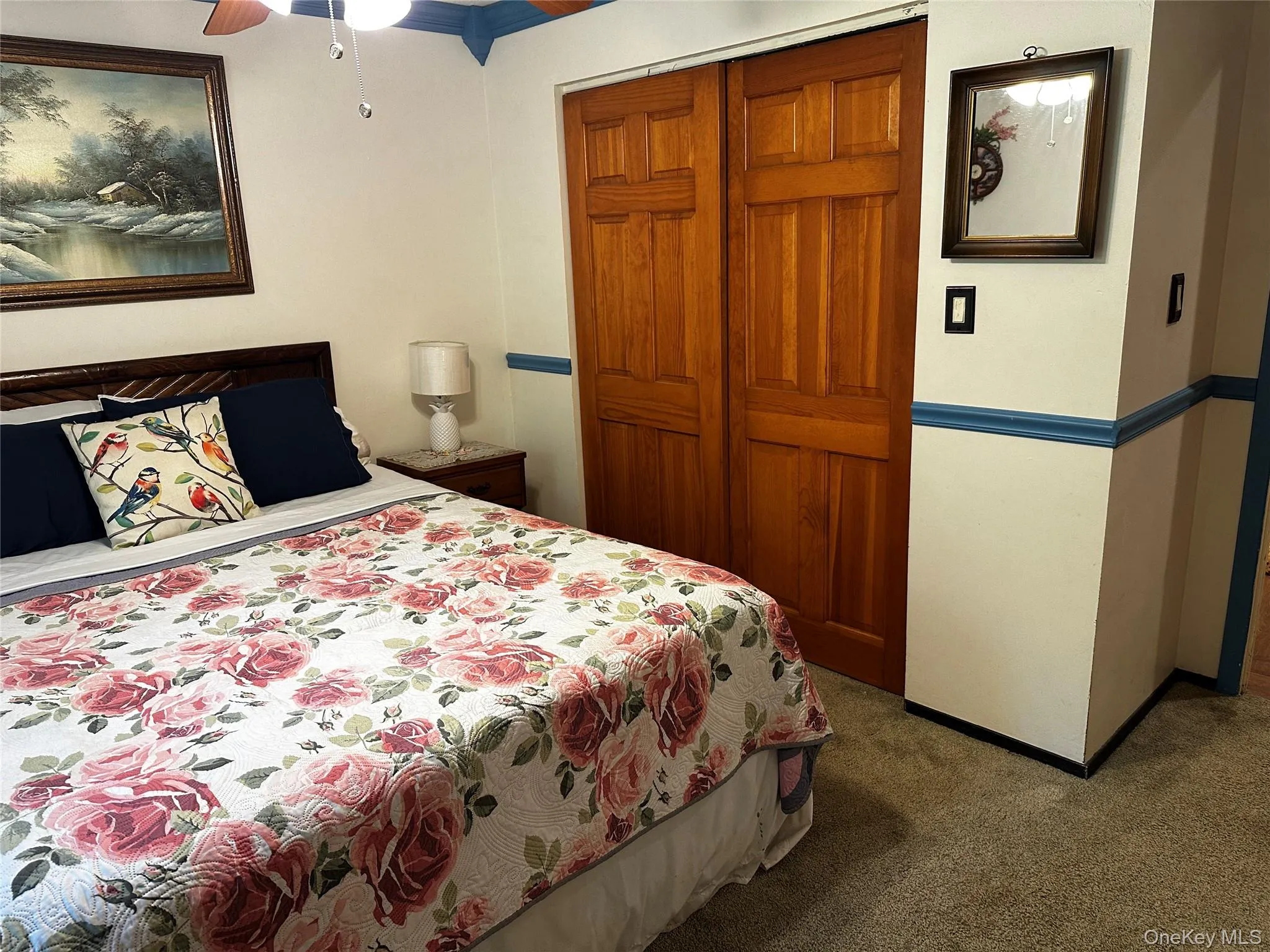 Carpeted bedroom featuring a closet and ceiling fan Carpeted bedroom featuring a closet and ceiling fan
