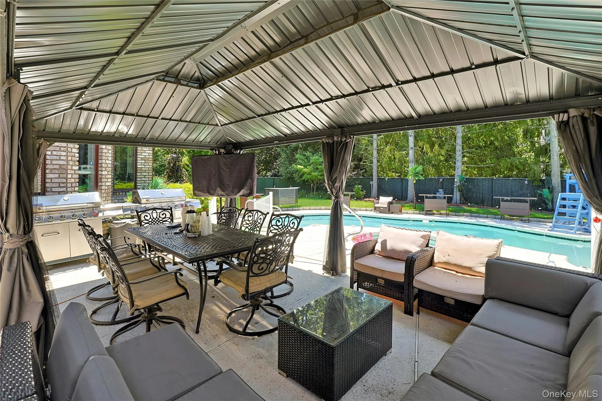 Fenced backyard with an outdoor living space and a patio Fenced backyard with an outdoor living space and a patio