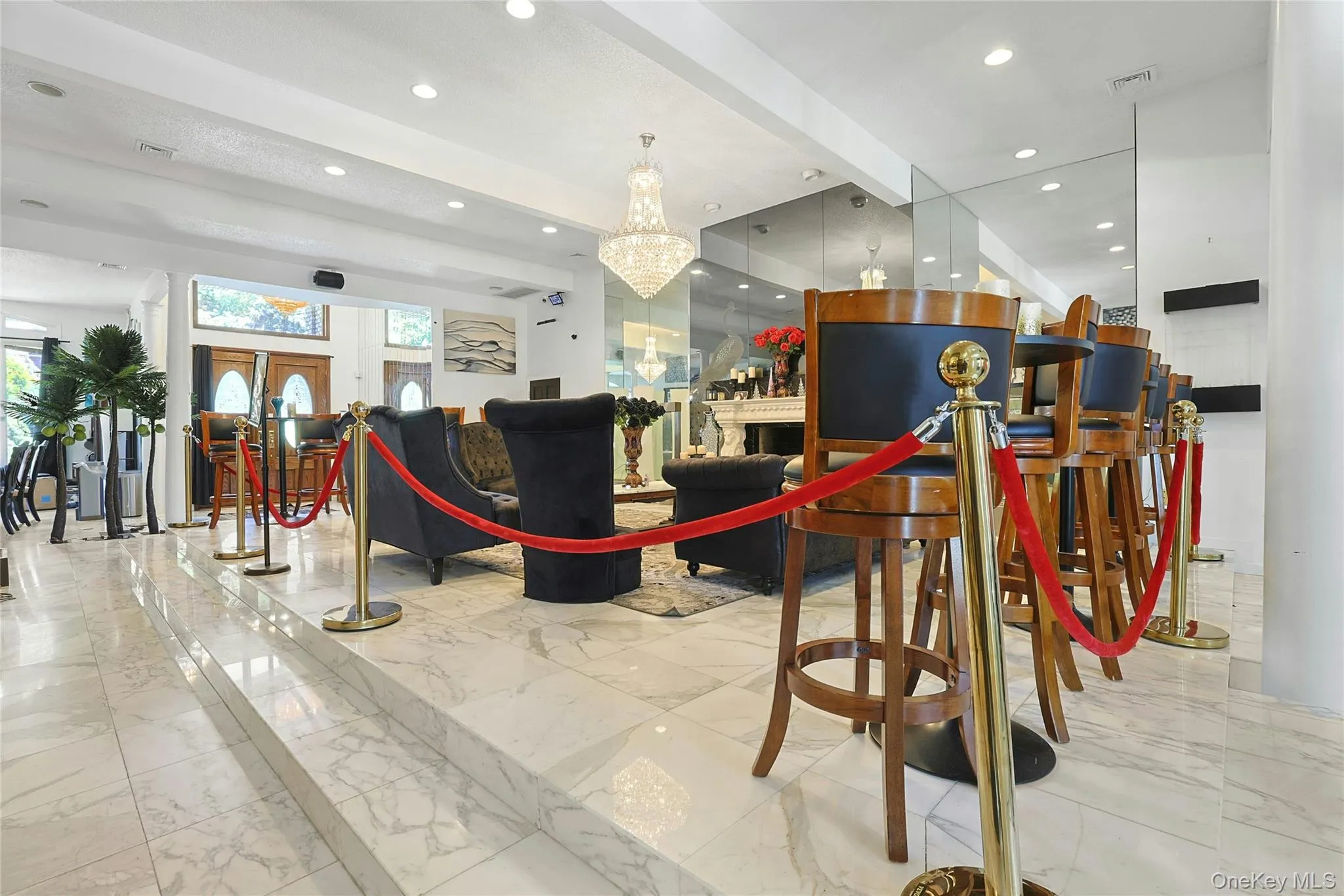 Welcome area featuring beamed ceiling, and a fireplace Welcome area featuring beamed ceiling, and a fireplace