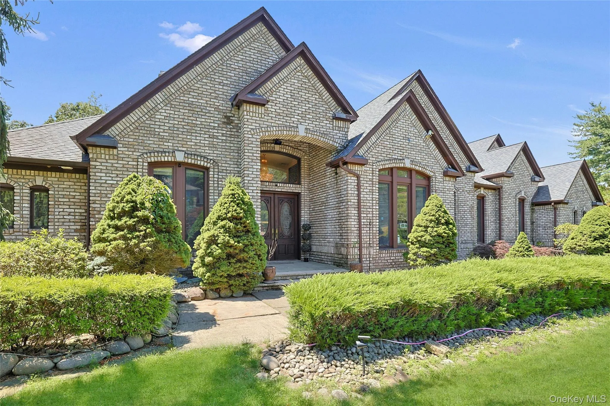 Featuring brick siding and a shingled roof Featuring brick siding and a shingled roof
