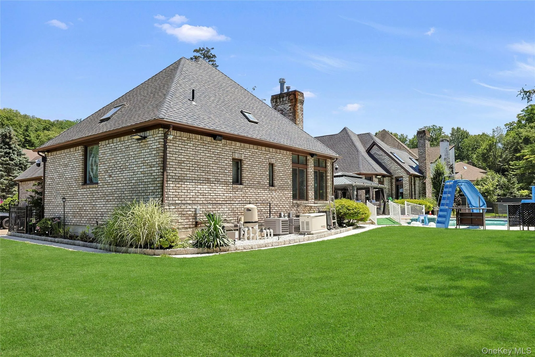Rear view of house featuring brick siding Rear view of house featuring brick siding