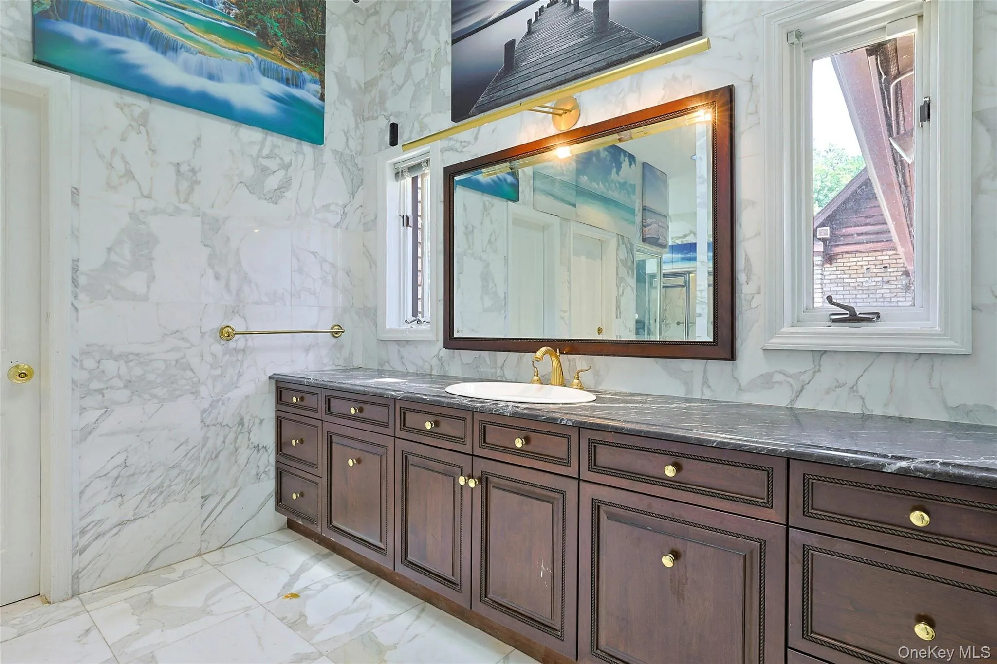 Full bathroom with light marble finish flooring, vanity, and tile walls Full bathroom with light marble finish flooring, vanity, and tile walls