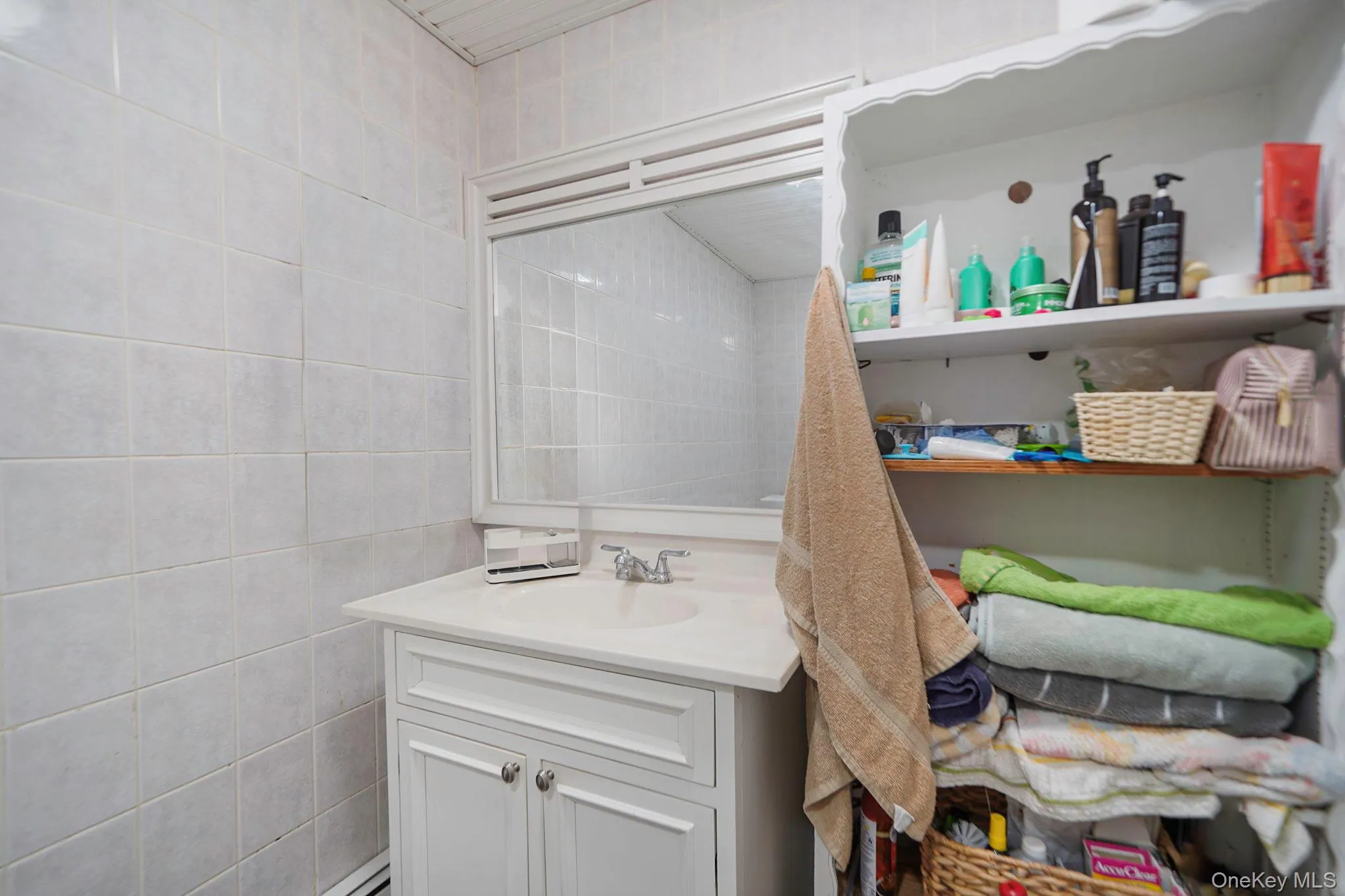 Bathroom featuring vanity and tile walls Bathroom featuring vanity and tile walls